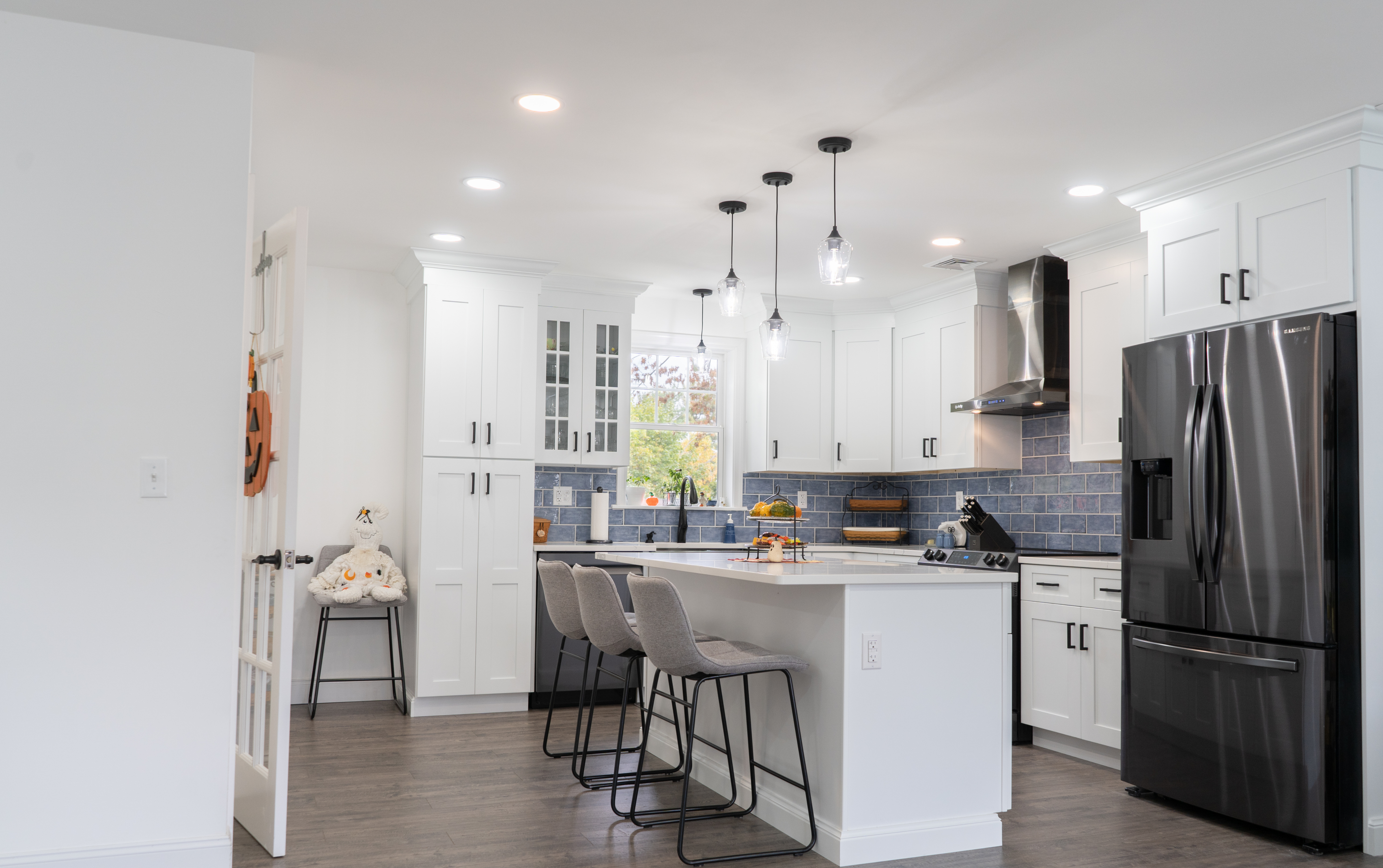 Remodeled kitchen with white cabinetry and black trim