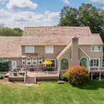 Brown house with yellow accents and new deck