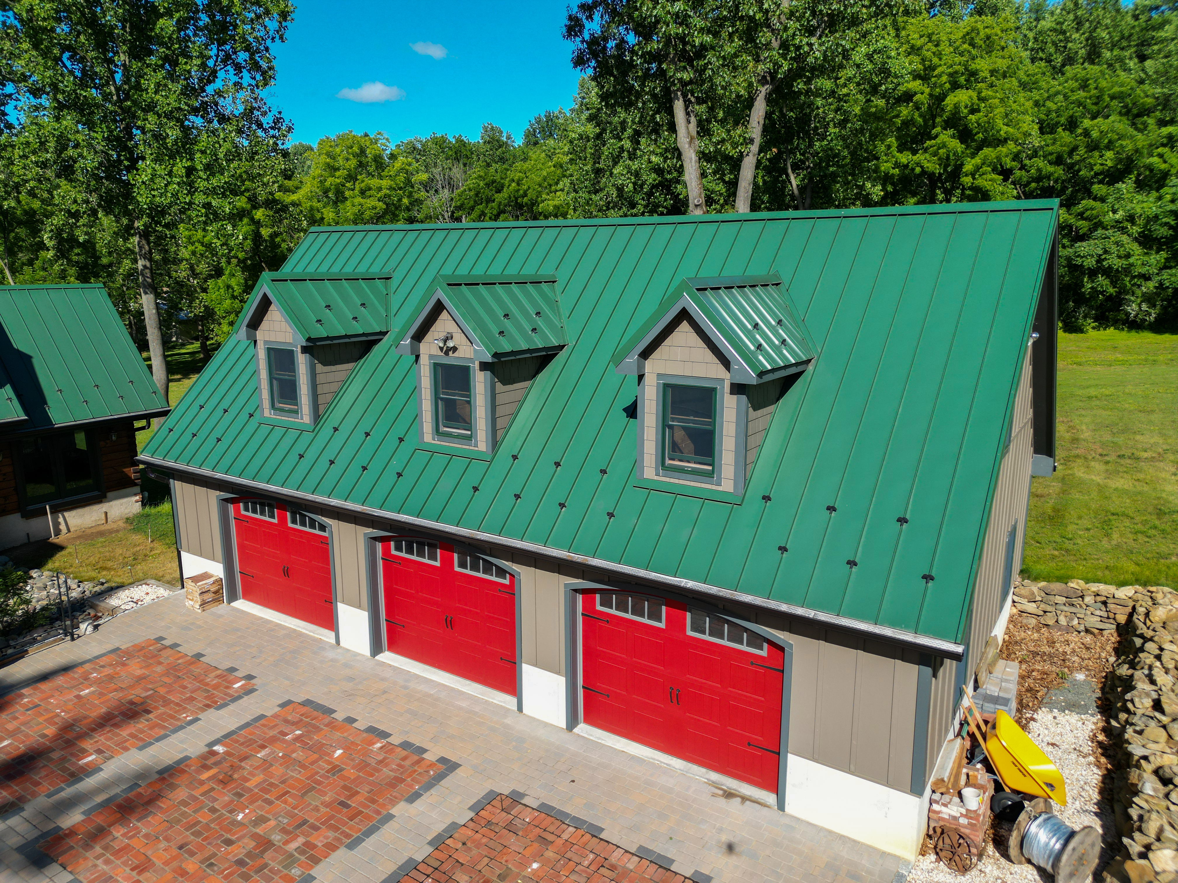 Green Standing-Seam Roof Red garage Doors